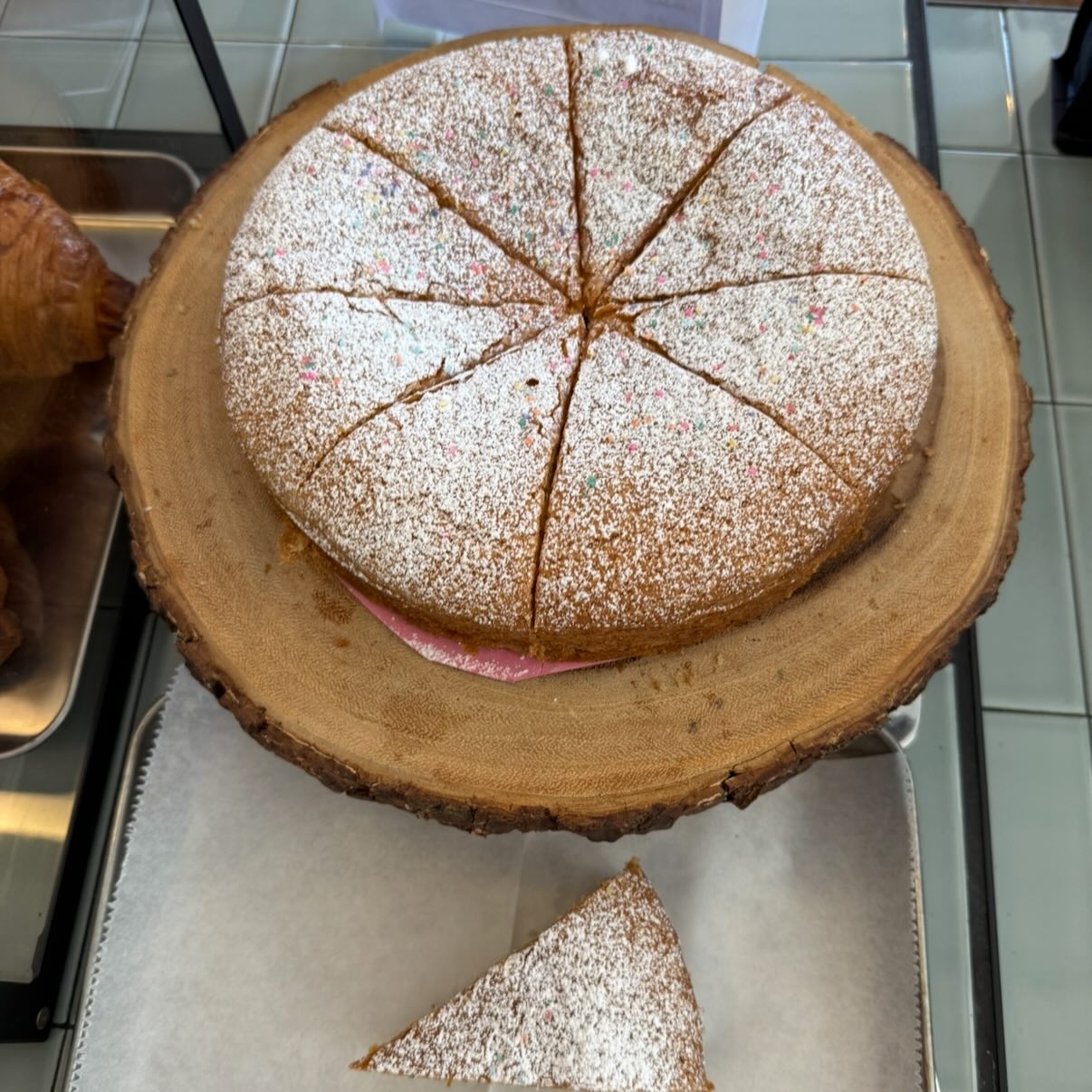 Sliced OG olive oil cake dusted with powdered sugar