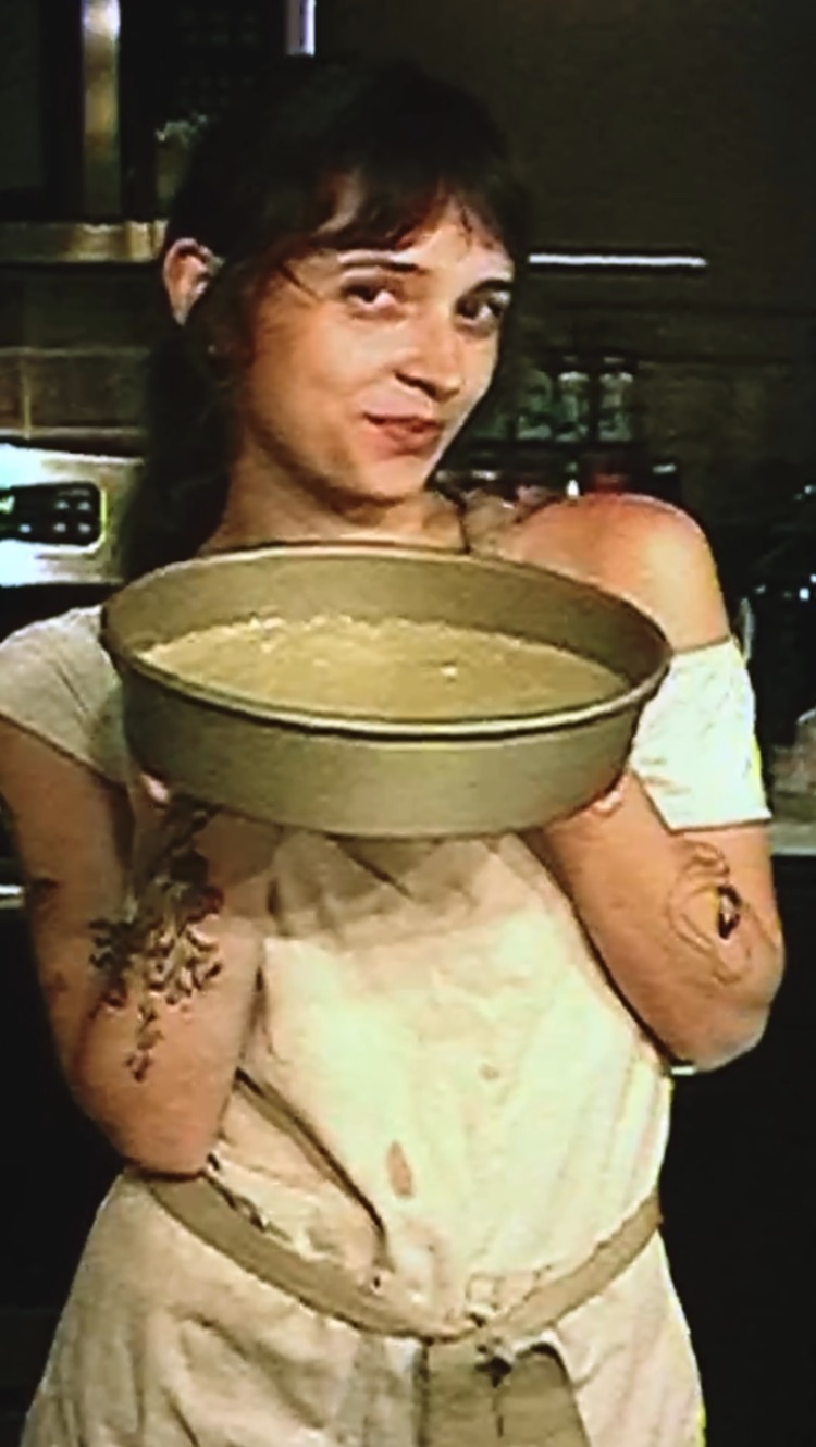 Hannah holding a pan of cake batter